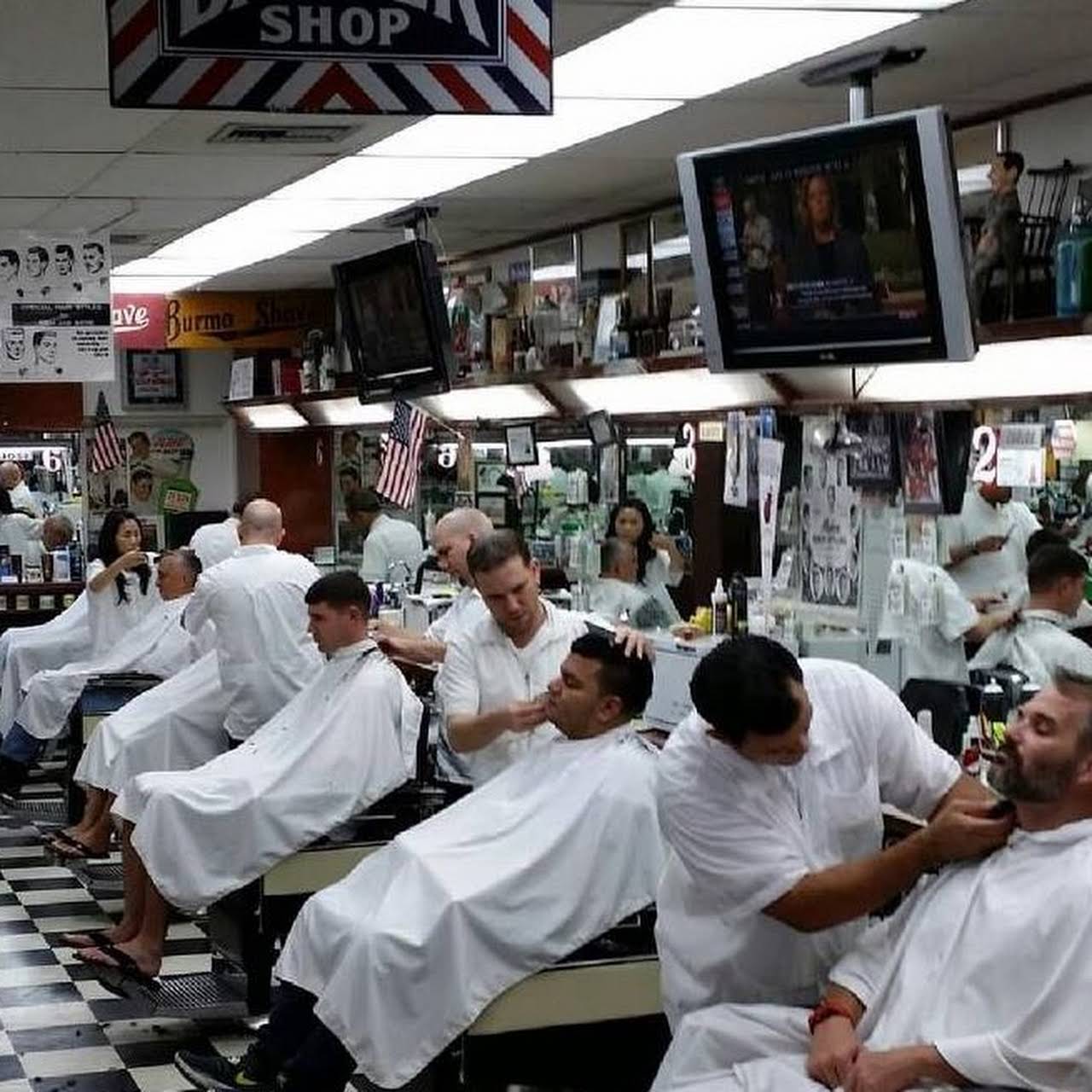 Six barbers trimming each customers hair in Carl's